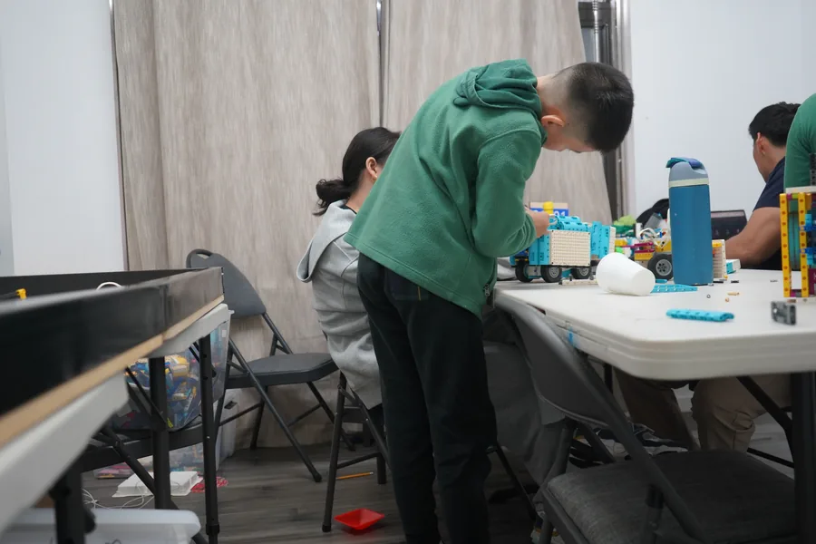 AI Future student working closely on a robotics project at camp