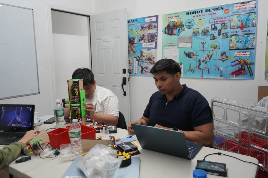 AI Future instructor helping students with robotics projects
