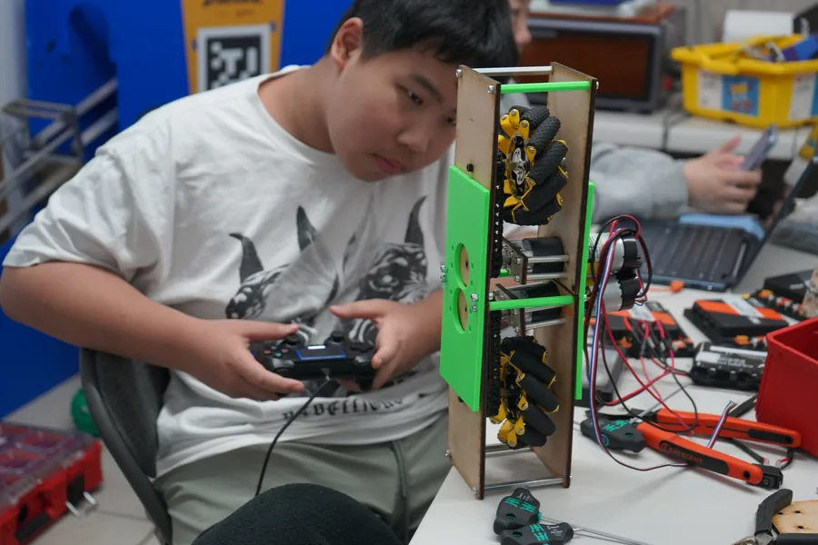 AI Future camper testing robot controls during a hands-on STEM project